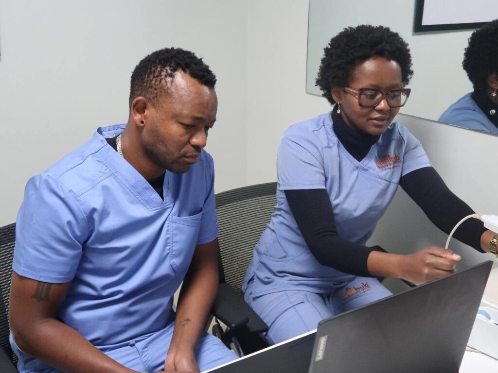 Certified trichologist Kagai John (KJ) taking classes in hair loss treatment